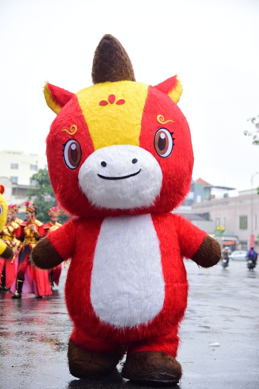 Bright red and yellow character costume at an outdoor festival