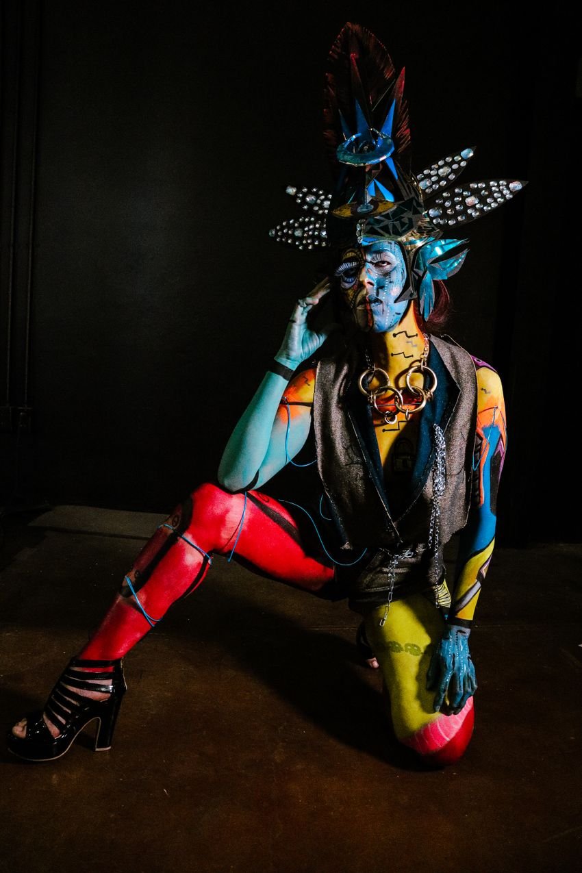 Colorful theatrical character with blue, yellow and red styling