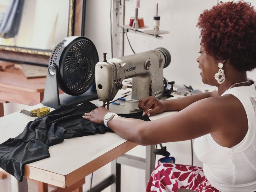 Maker working at a sewing machine in a bright studio